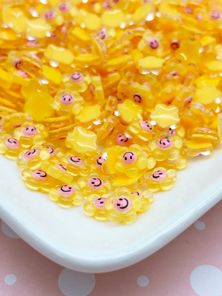 a white plate topped with lots of yellow beads