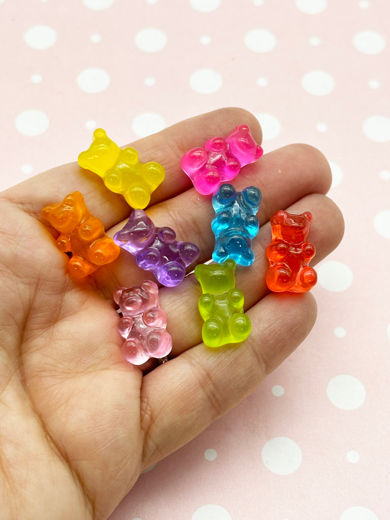 a hand holding a small group of gummy bears