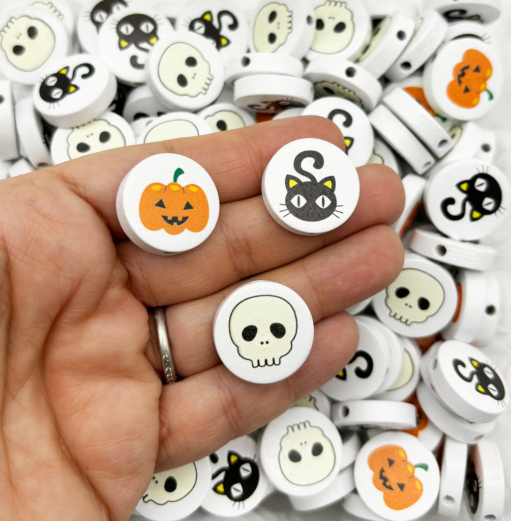 a hand holding a bunch of halloween buttons