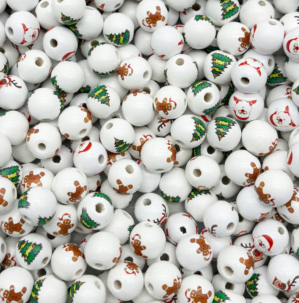 a pile of white ceramic beads with christmas decorations on them