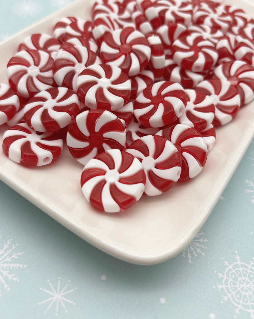 a white plate topped with red and white candy canes