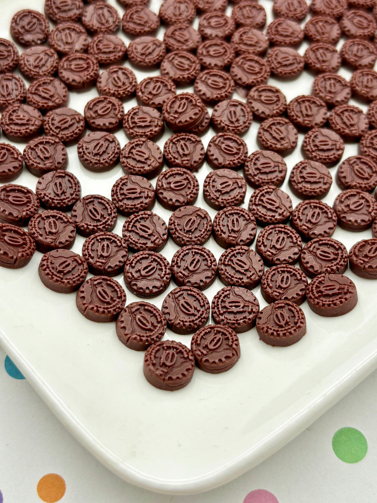 a white plate topped with chocolate cookies on top of a table