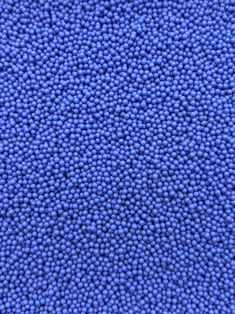 The image is a close-up of numerous small, round blue beads or spheres, creating a textured and visually striking pattern.