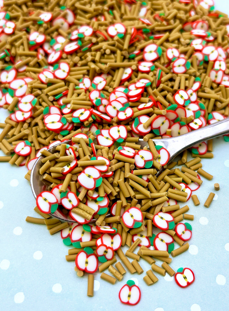 a pile of sprinkles and a spoon on a table