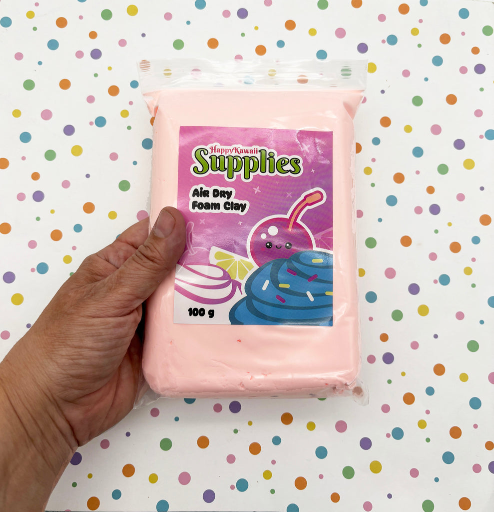 A hand is holding a package of pink foam clay, which is labeled as "Happy Kaili Supplies" and "Air Day Foam Clay".