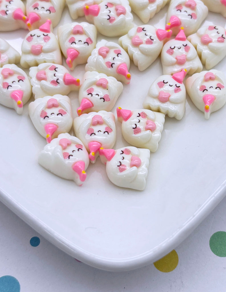 a white plate topped with marshmallows shaped like cats