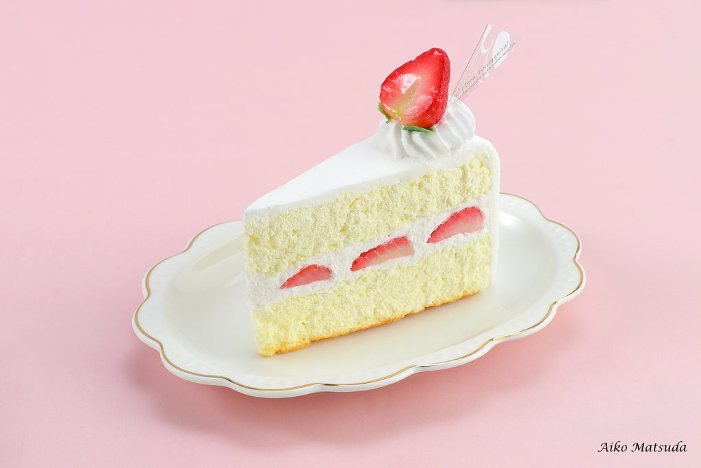 a piece of cake with a strawberry on top