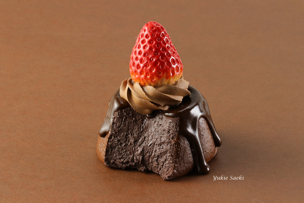 a piece of chocolate cake with a strawberry on top