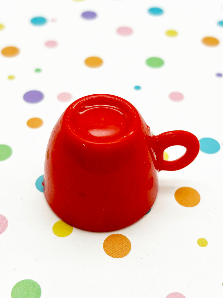 a red cup sitting on top of a table