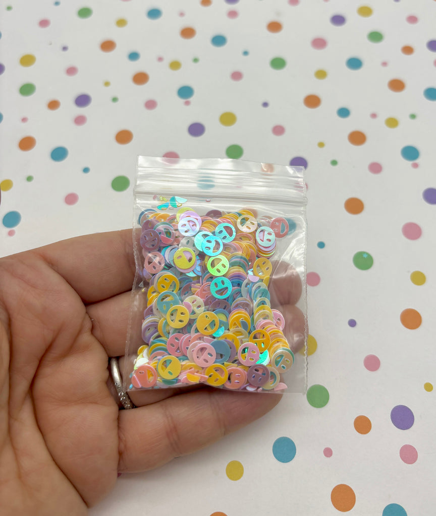 a person holding a bag of buttons in their hand