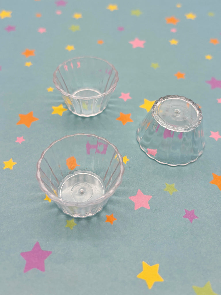 three small clear bowls sitting on top of a table