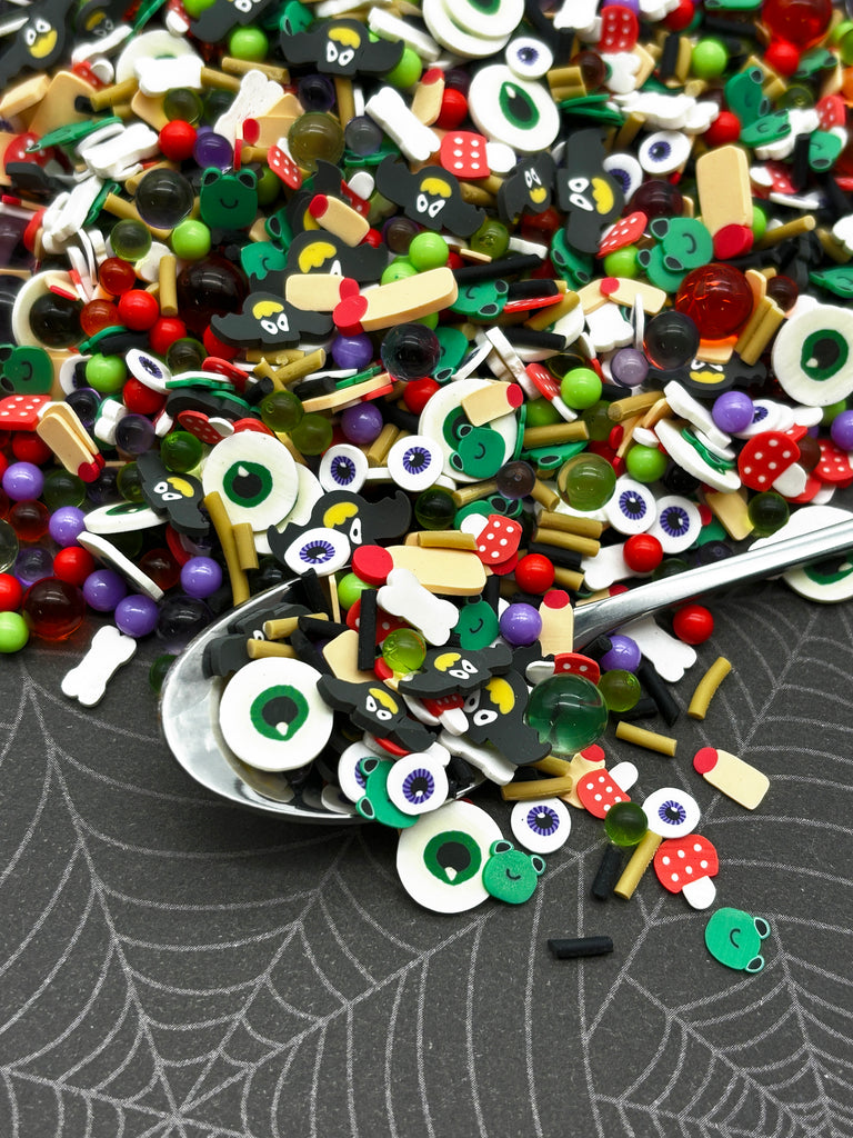 a spoon filled with lots of different types of buttons