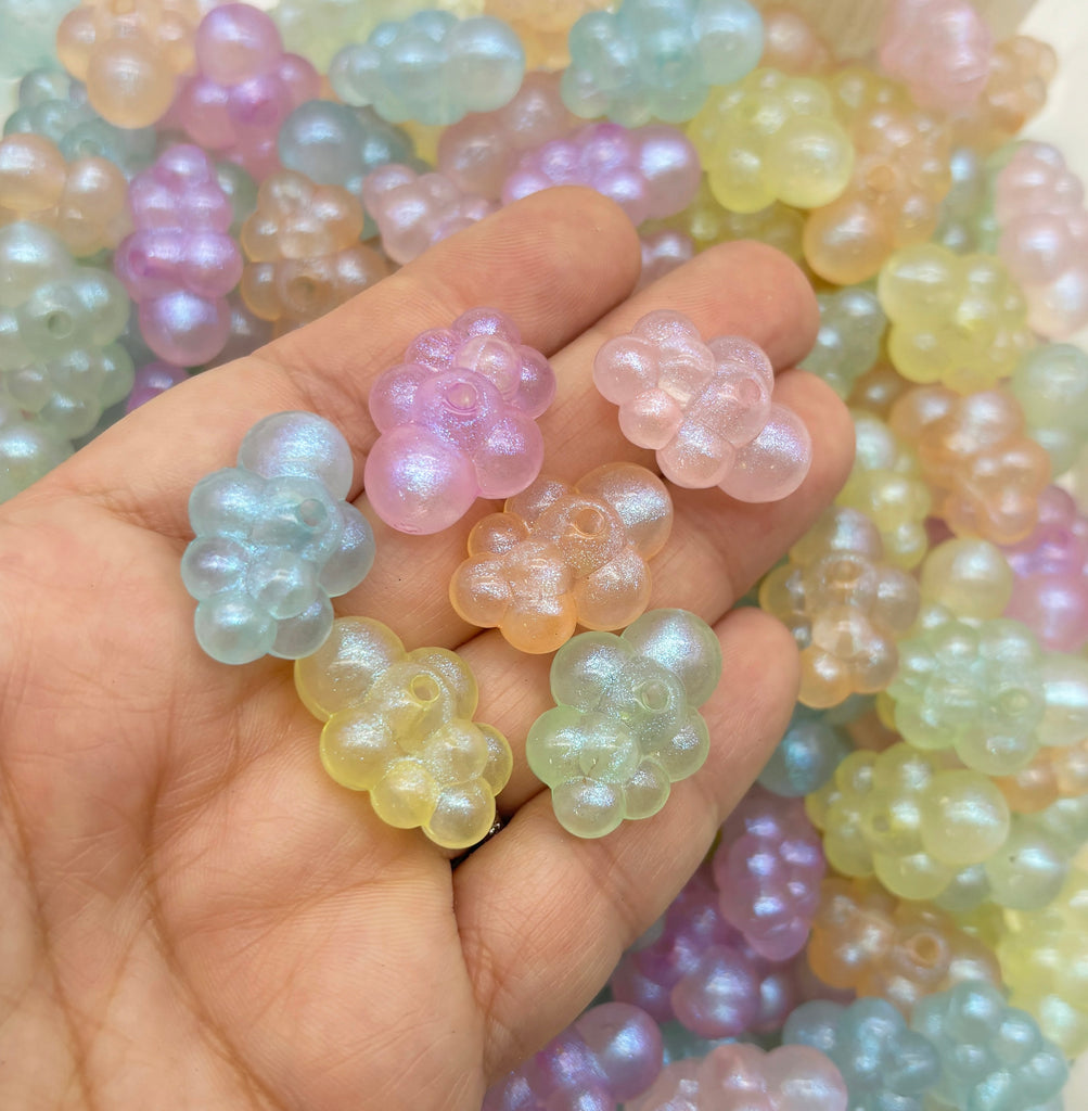 a person holding a bunch of beads in their hand