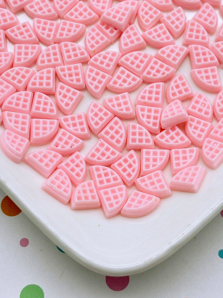 a white plate topped with pink heart shaped cookies