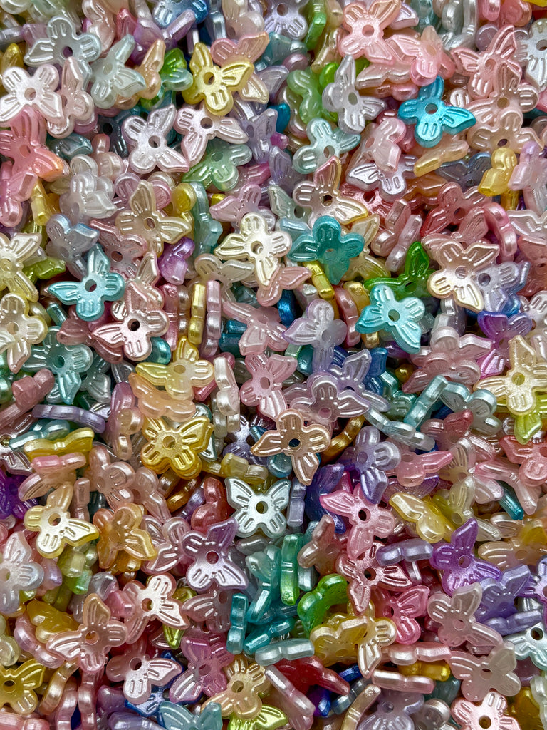 The image is a colorful assortment of small, multicolored beads or buttons, resembling a collection of butterflies or other small, decorative objects.
