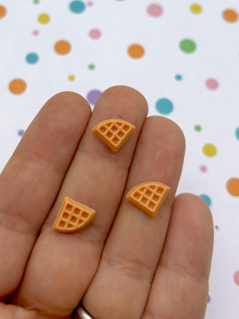 a person holding two small pieces of food in their hand