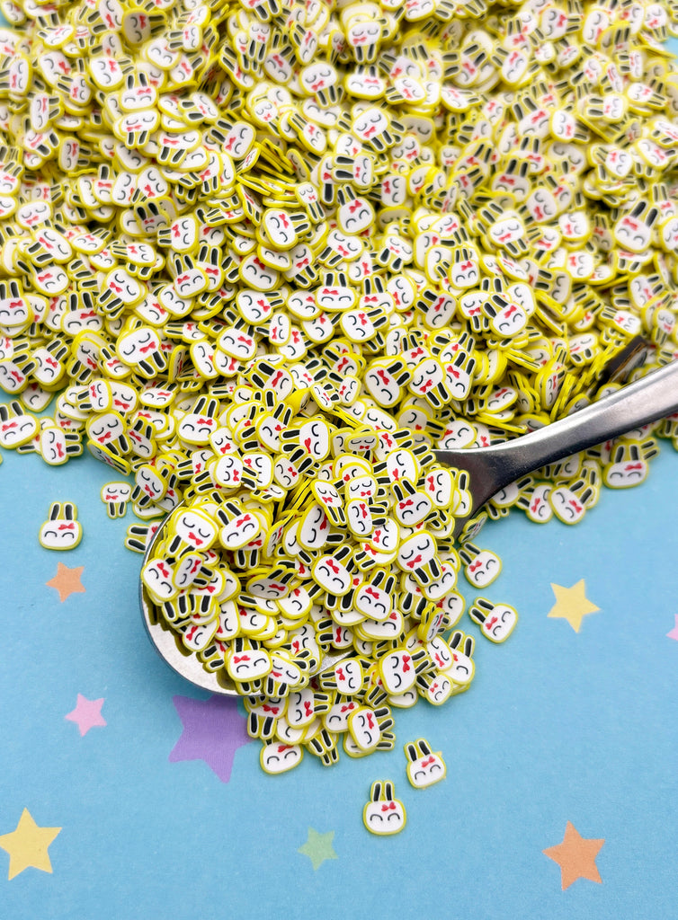 a spoon full of green and white sprinkles