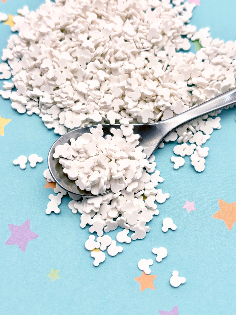 a spoon full of white sprinkles on a blue background