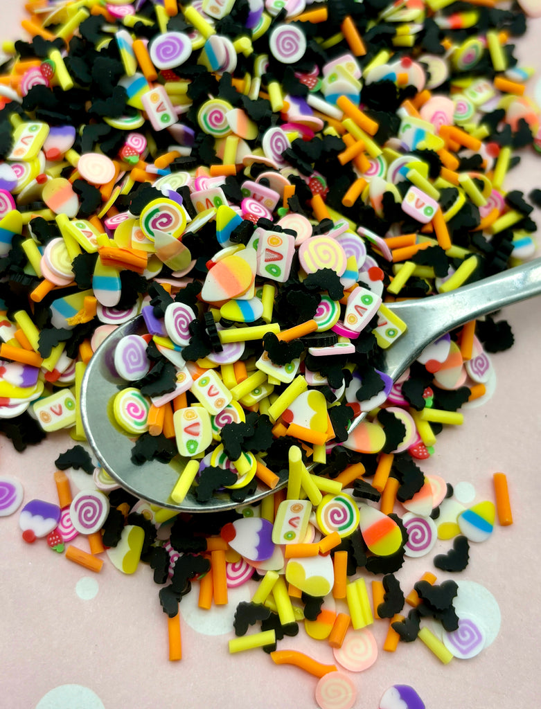 a spoon full of candy candies on a table