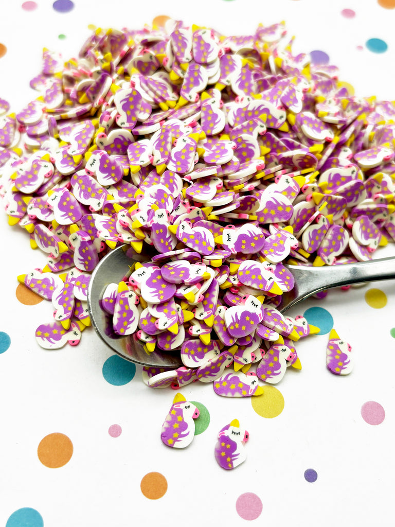 a spoon full of purple and yellow confetti