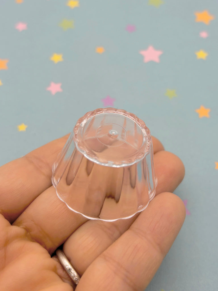 a hand is holding a clear plastic object