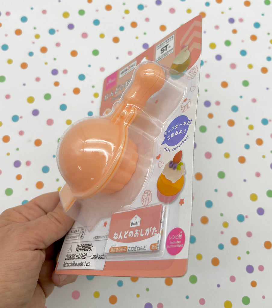 a hand holding a baby pacifier in a package