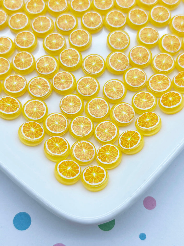 a white plate topped with sliced oranges on top of a table