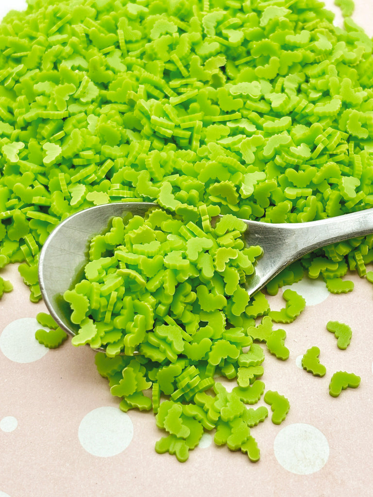 a spoon full of green peas on a polka dot tablecloth