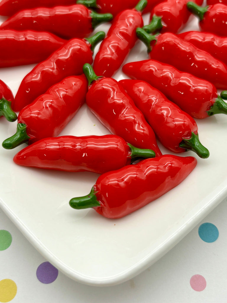 a white plate topped with lots of red peppers