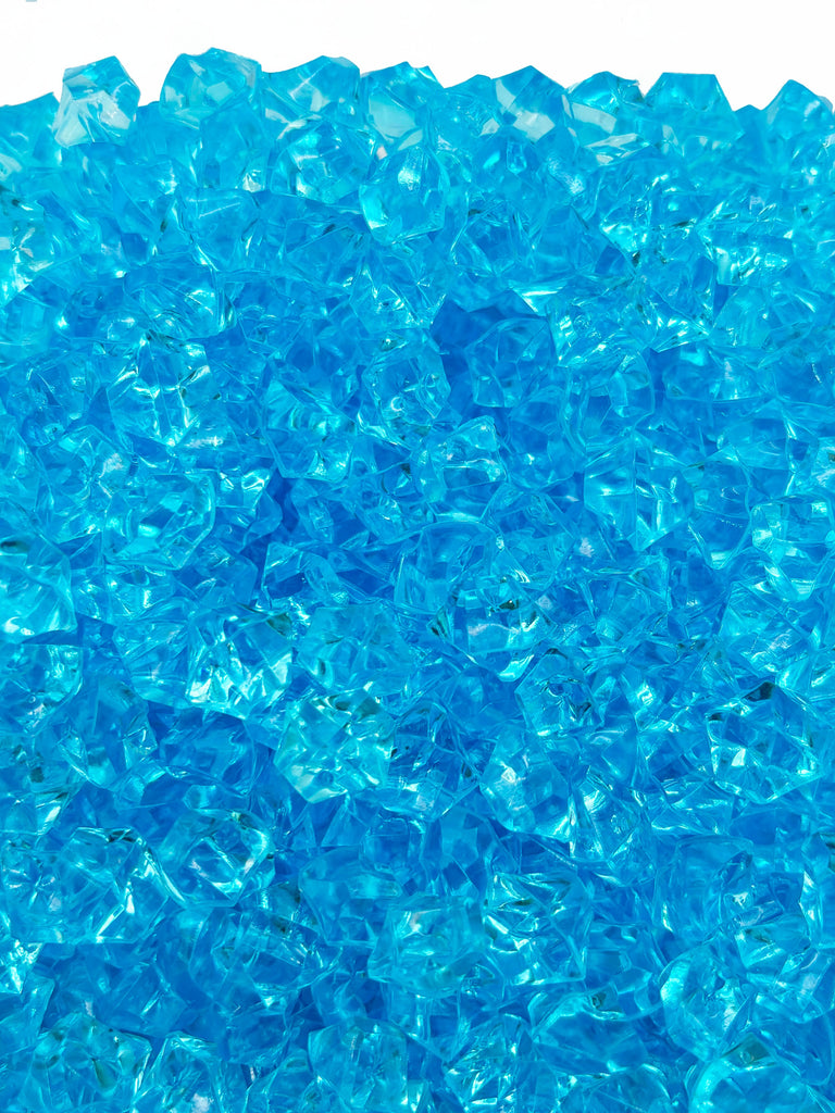 a pile of blue glass chips sitting on top of a table