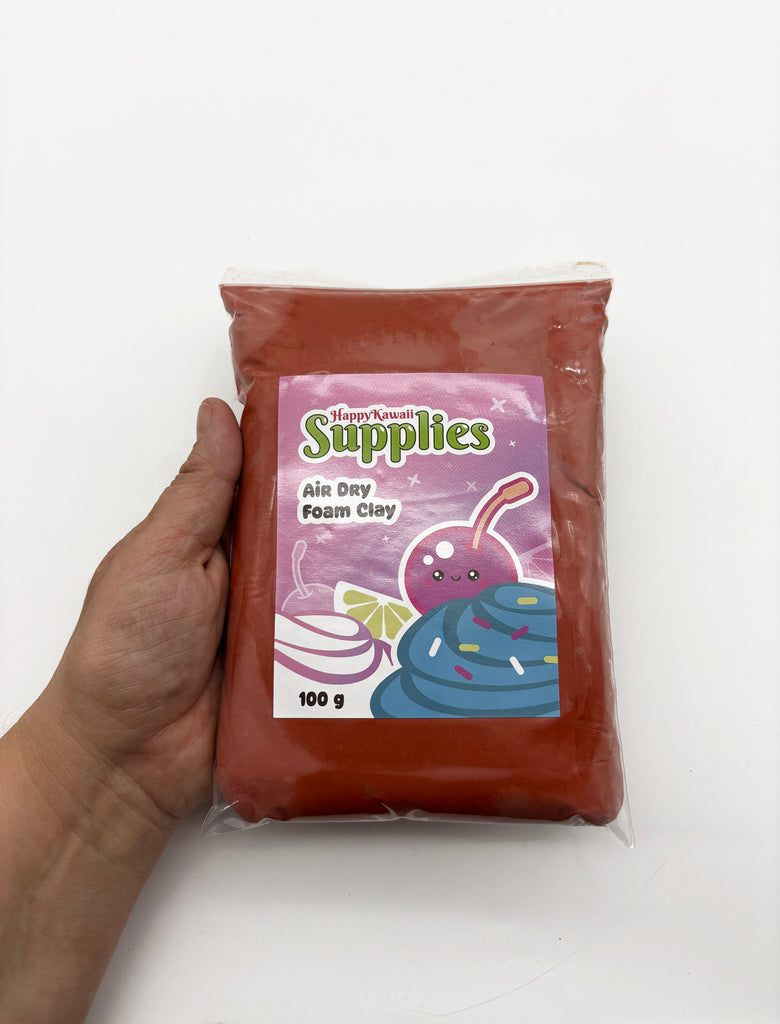 A hand holding a bag of air day foam clay with a cartoon character on the label.