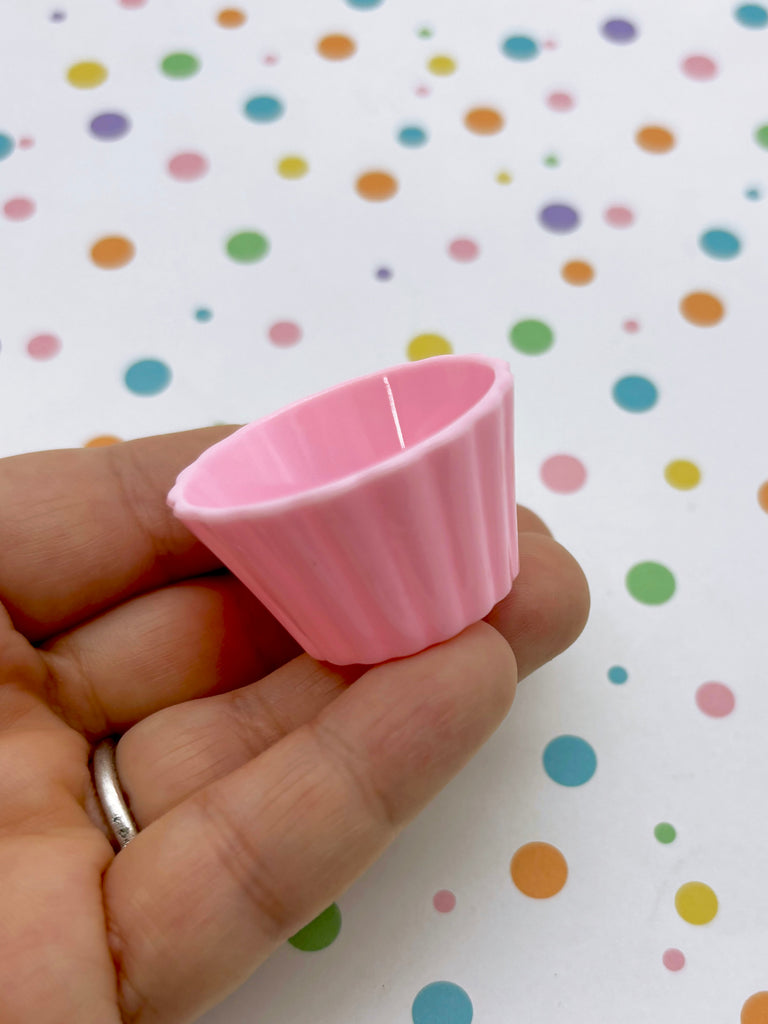 a person holding a pink cup in their hand