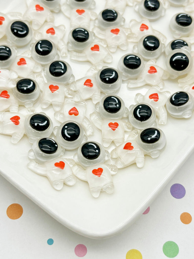 a white plate topped with lots of black and white candies