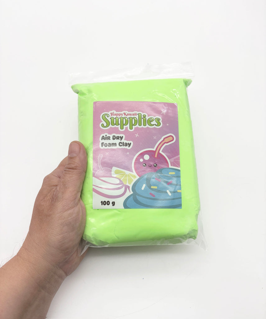 A hand holding a package of air day foam clay.