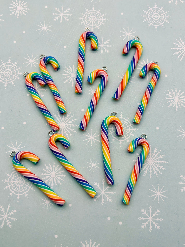 a collection of colorful candy canes arranged on a snowy background.