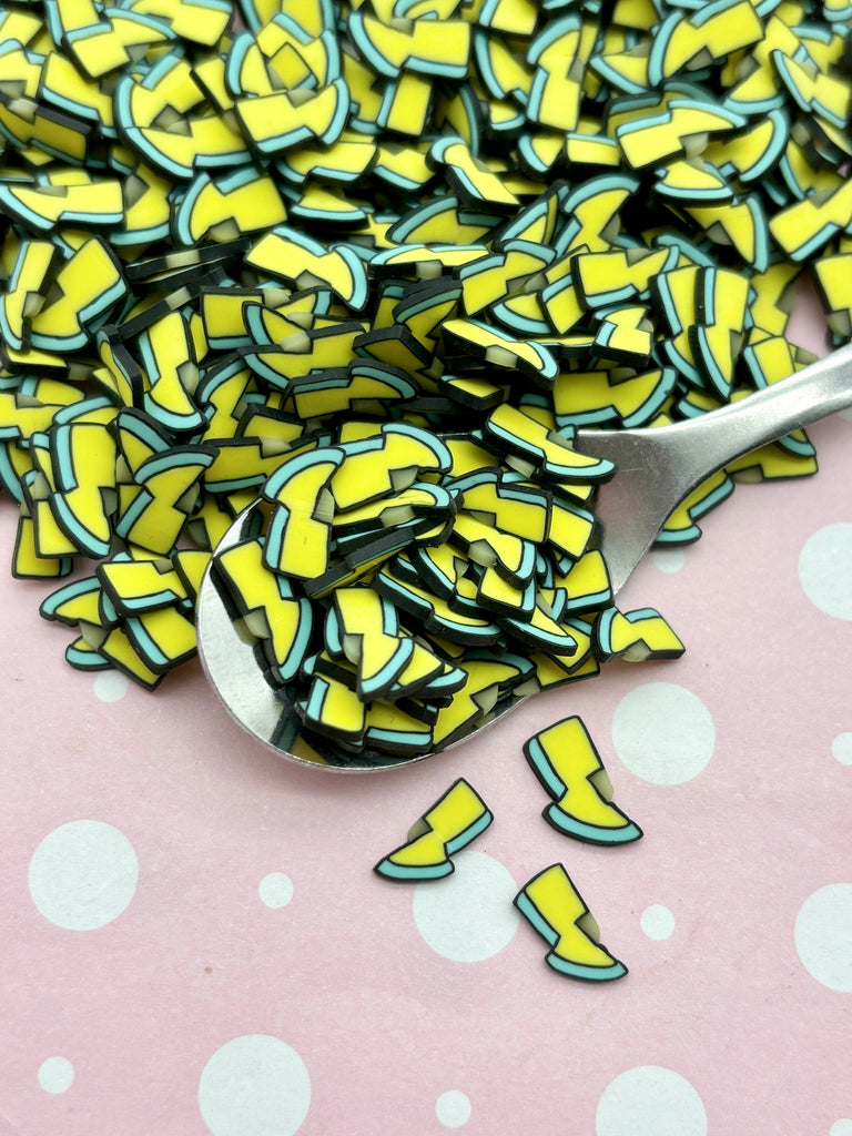 a spoon full of yellow and black confetti