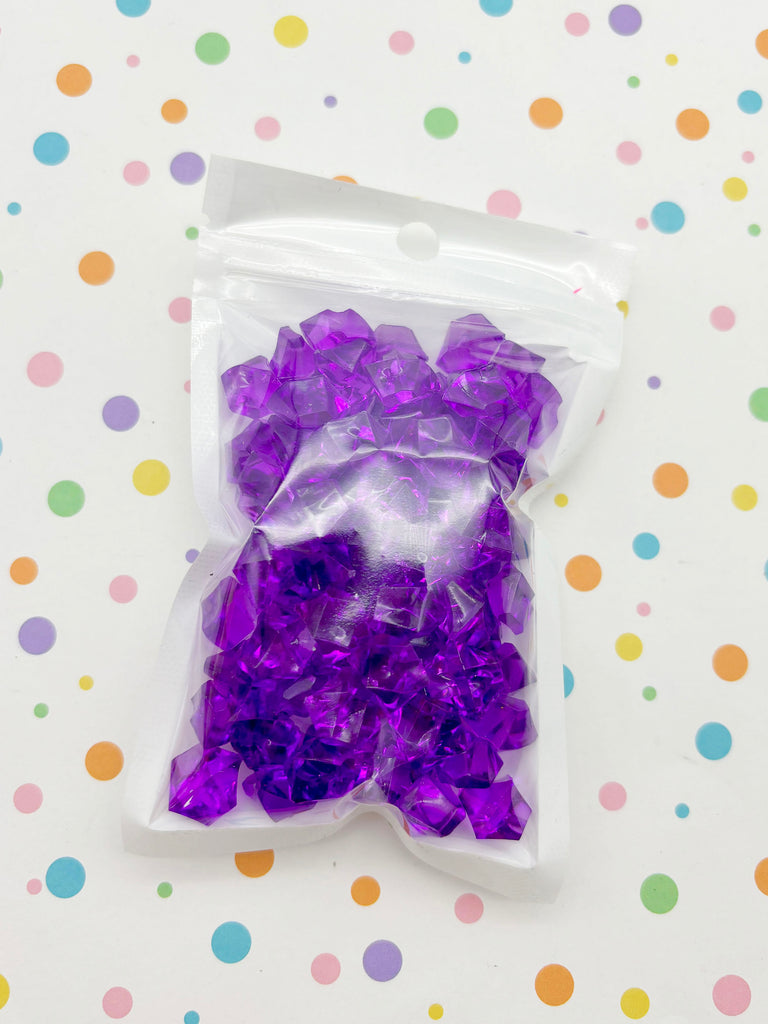 a bag of purple confetti sitting on top of a table