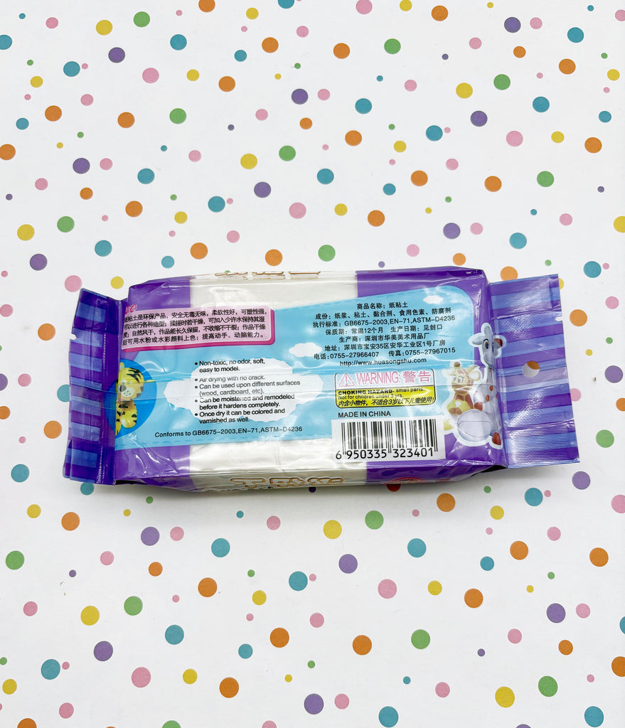 a colorful polka dot background with a purple and blue package of what appears to be a toy or snack.