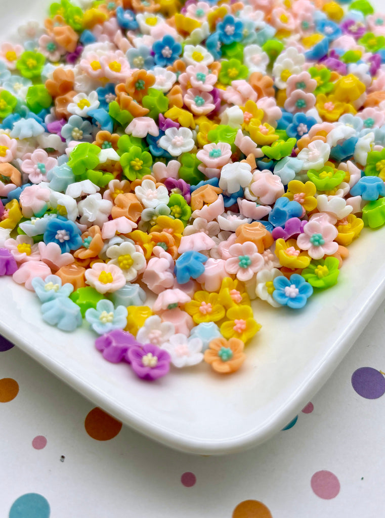 a white plate topped with lots of colorful flowers