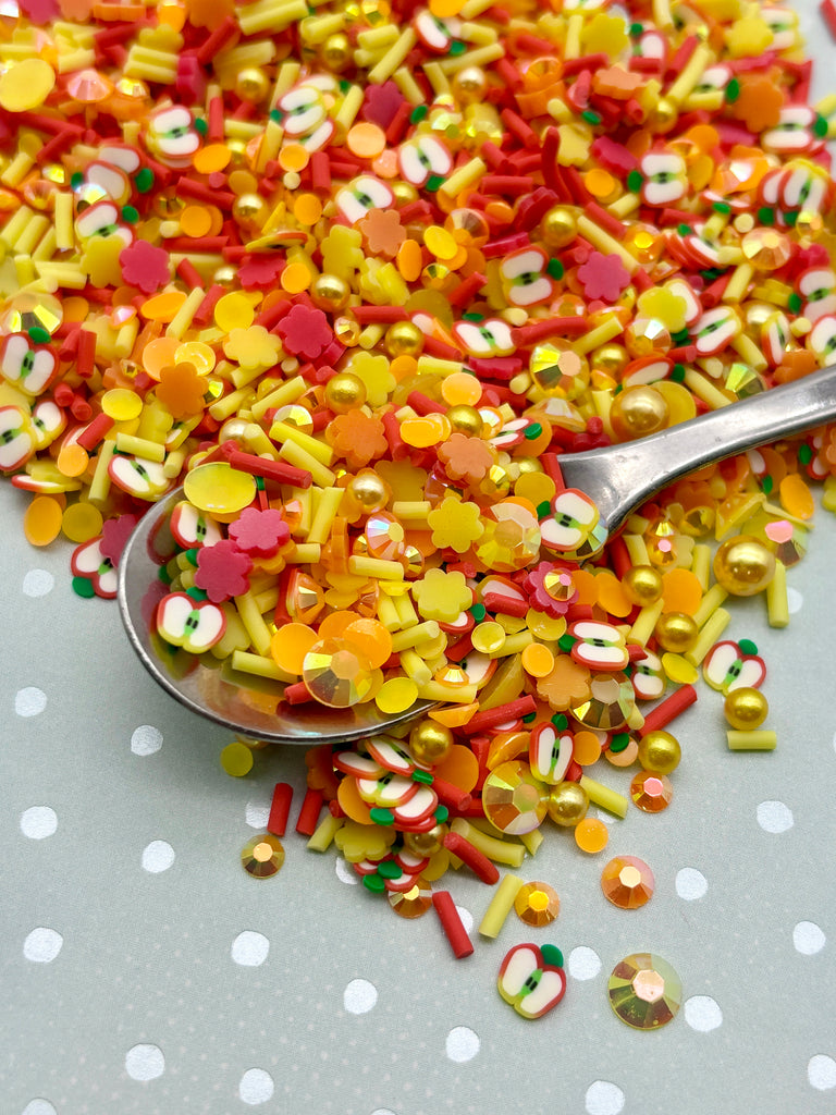 a spoon full of candy sprinkles on a polka dot tablecloth