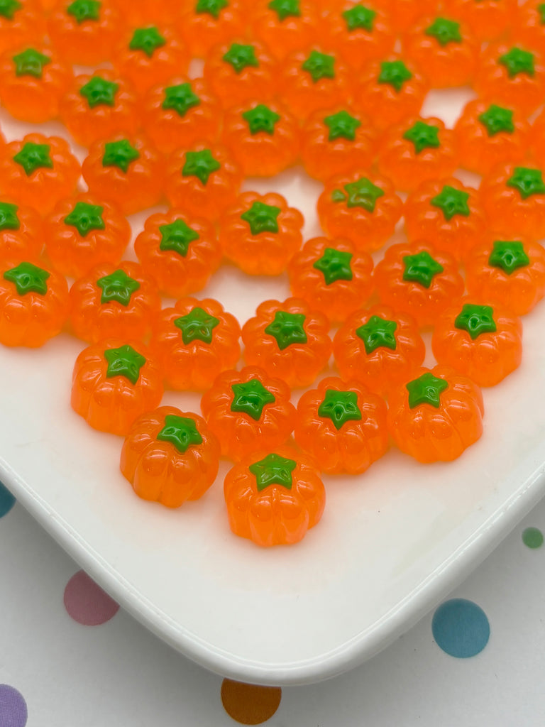 a white plate topped with lots of orange gummy bears