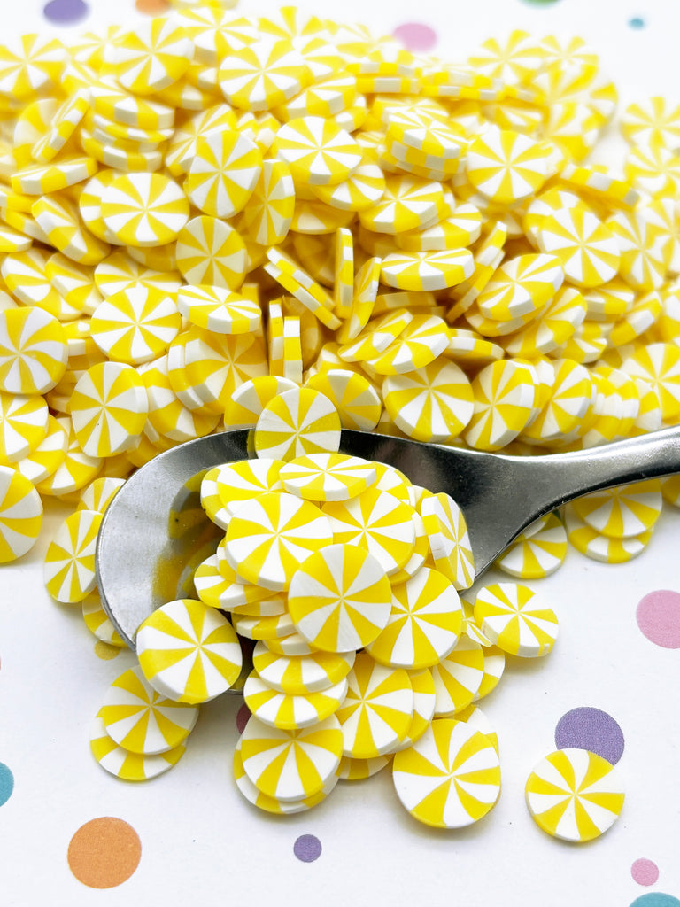 a spoon full of yellow and white candies