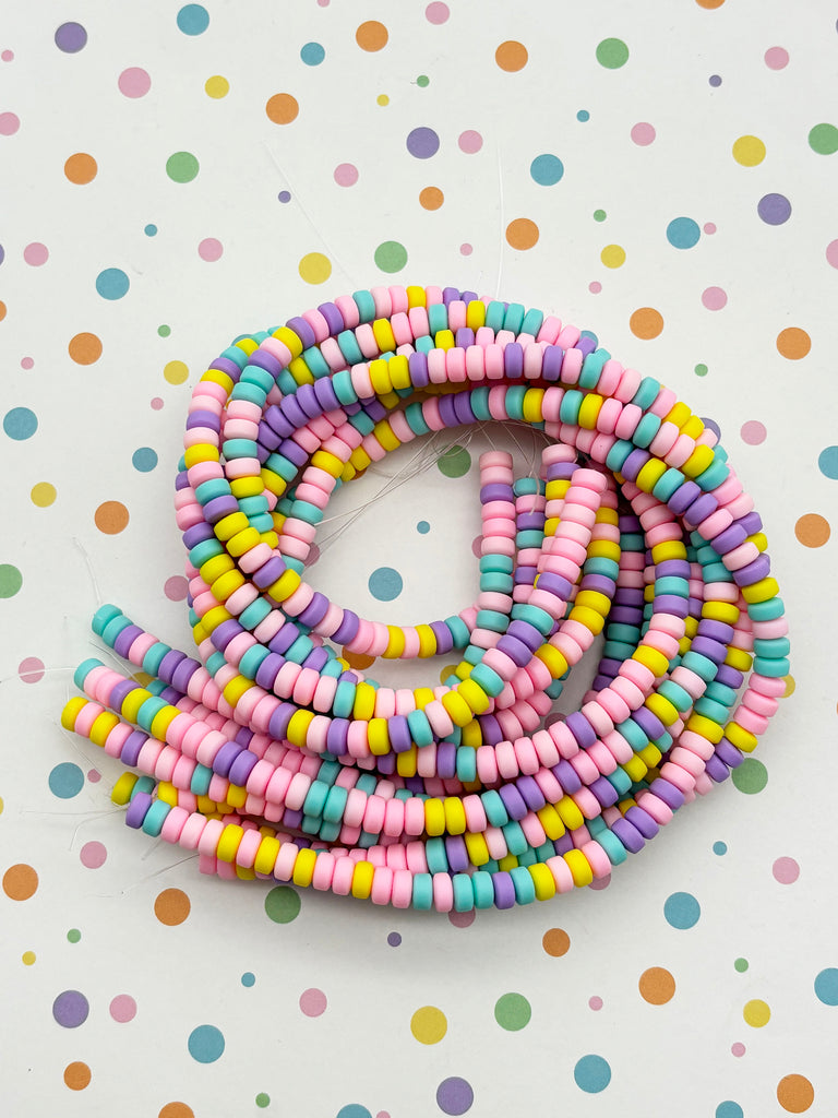 a group of multicolored beads sitting on top of a table