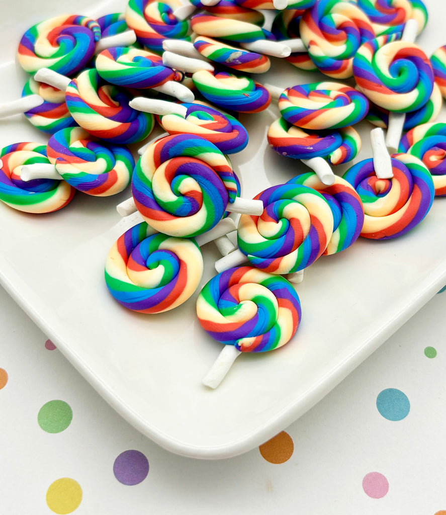 a white plate topped with lollipops on top of a table