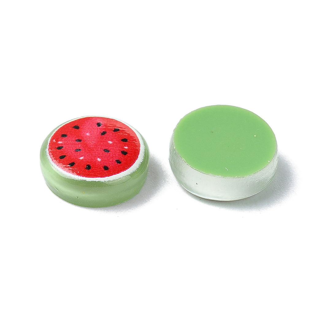 two small, round objects with a watermelon design on them.