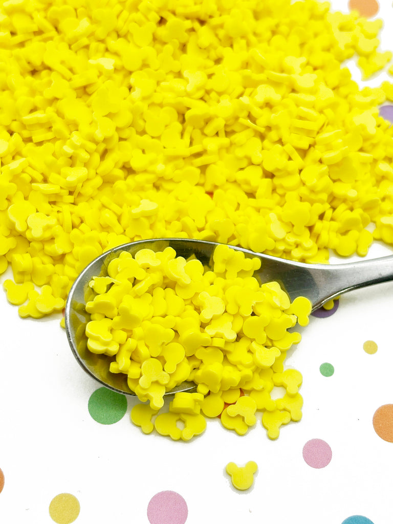 a spoon full of yellow confetti on a polka dot tablecloth