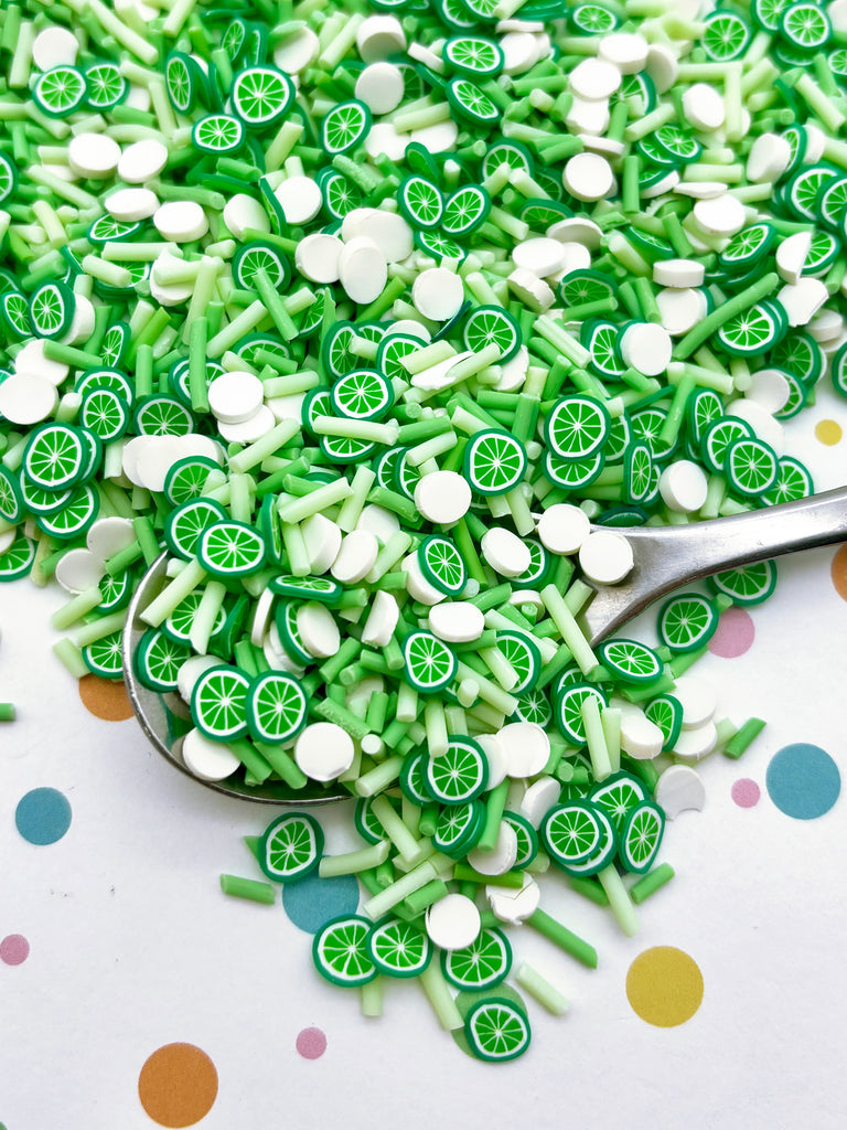 a spoon filled with green and white sprinkles