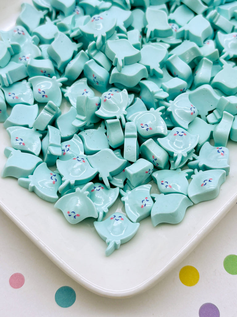 a white plate topped with lots of blue candies