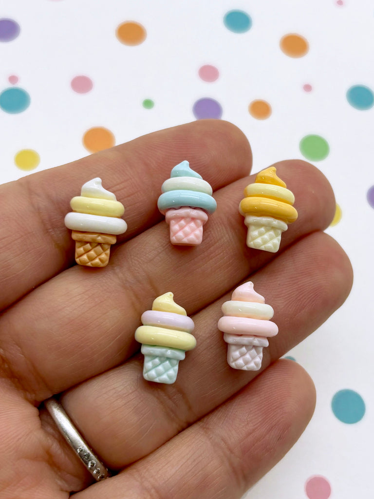 a hand holding five miniature ice cream cones