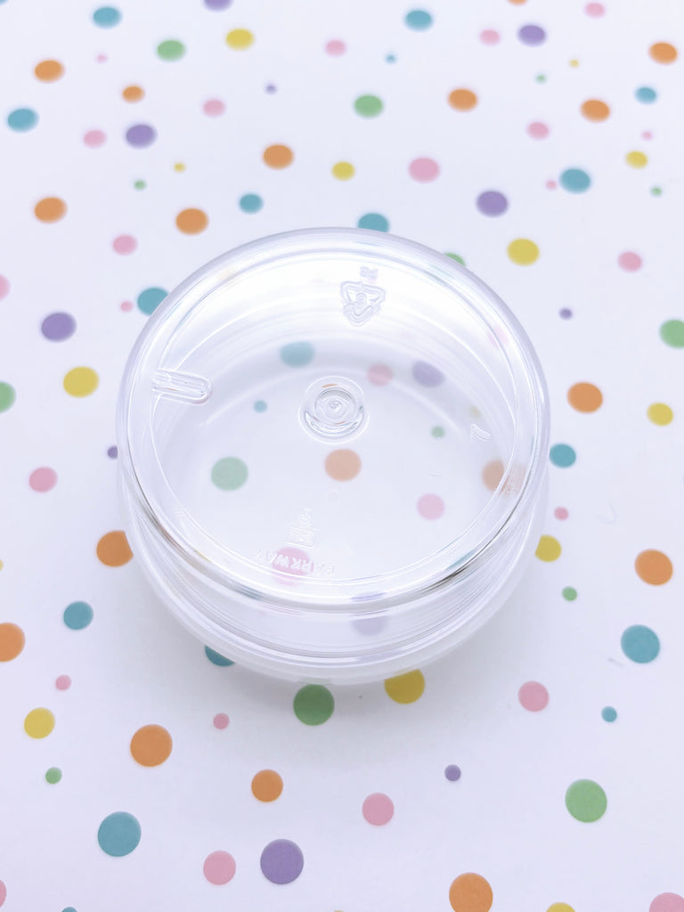 a plastic cup sitting on top of a table